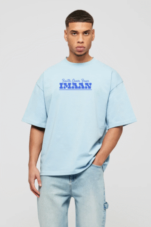 Man wearing sky blue oversized t-shirt with “Faith Over Fear – Imaan” design on chest, Islamic faith wear from VedFra