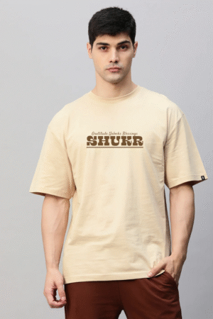 Man in beige oversized t-shirt with “Gratitude unlocks blessing – SHUKR” print, modest streetwear by VedFra